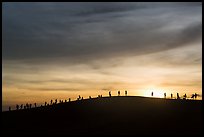 Tourists watching sunset from dune. Mui Ne, Vietnam (color)