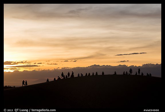Tourists on dune ridge at sunset. Mui Ne, Vietnam (color)