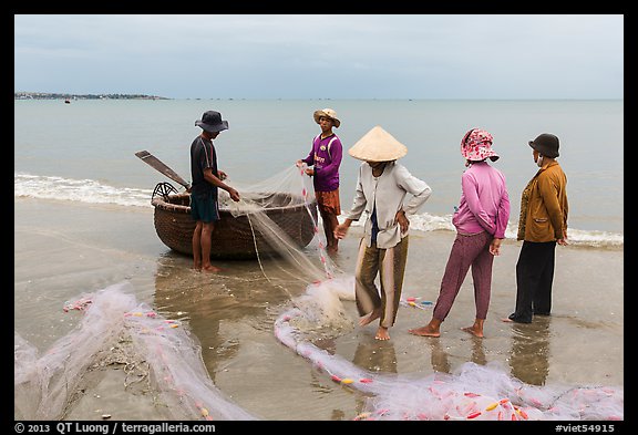 Fishermen, net, and coracle boat. Mui Ne, Vietnam