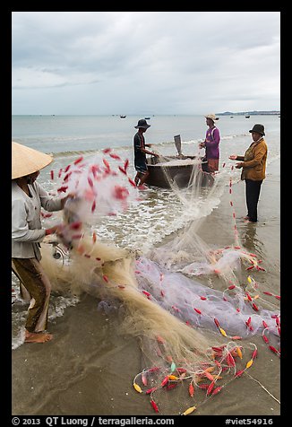 Woman folding fishing net. Mui Ne, Vietnam