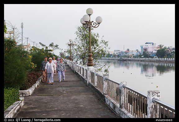 Elderly women strolling on riverfront. Tra Vinh, Vietnam (color)