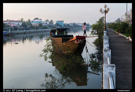 Woman in high heels walking out of barge. Tra Vinh, Vietnam (color)