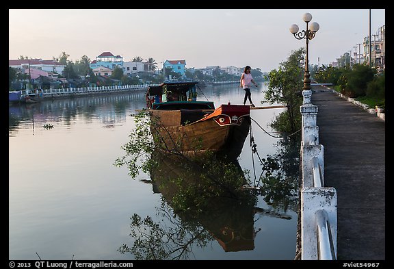 Woman in high heels walking out of barge. Tra Vinh, Vietnam