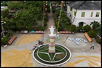 View of drying rice and statue from church tower. Tra Vinh, Vietnam (color)