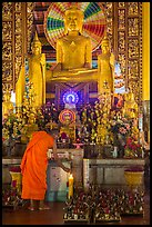 Monk lighting incense at  Ang Pagoda altar. Tra Vinh, Vietnam (color)