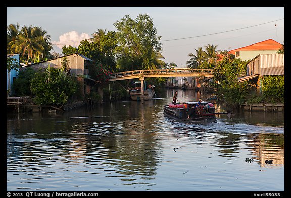 Barge and canal-side houses. Mekong Delta, Vietnam (color)