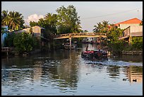 Barge and canal-side houses. Mekong Delta, Vietnam (color)