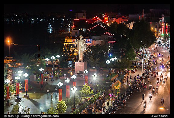 Mekong River, Ho Chi Minh statue, and street at night. Can Tho, Vietnam (color)