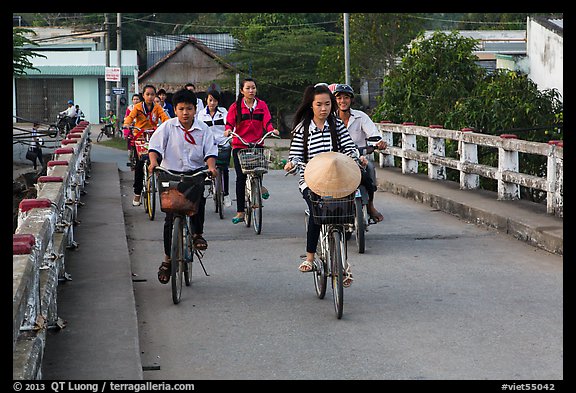 Children bike on way to school, Phung Diem. Can Tho, Vietnam (color)