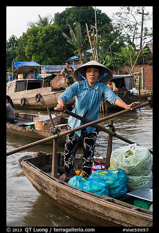 Woman using the x-shape paddles. Can Tho, Vietnam