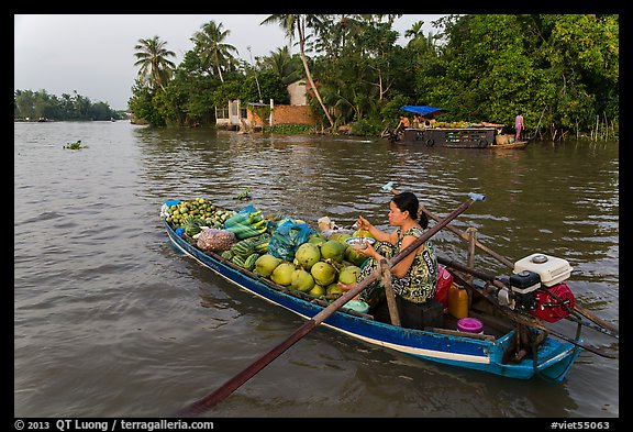 Woman pausing to eat noodles on the river. Can Tho, Vietnam