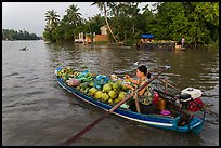 Woman pausing to eat noodles on the river. Can Tho, Vietnam (color)