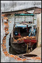 Boat loaded with bricks seen from brick wall opening. Can Tho, Vietnam ( color)