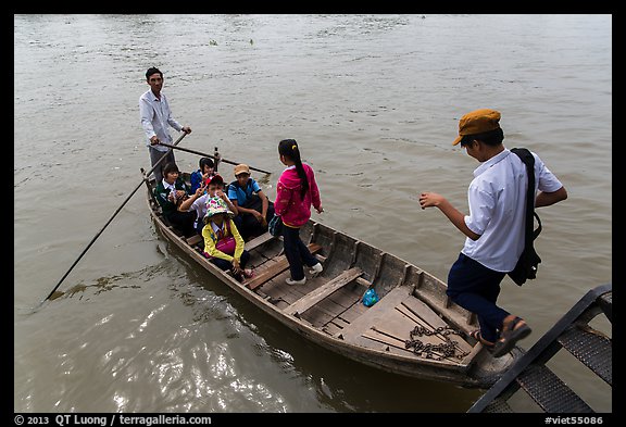 Schoolchildren stepping onto boat. Can Tho, Vietnam (color)