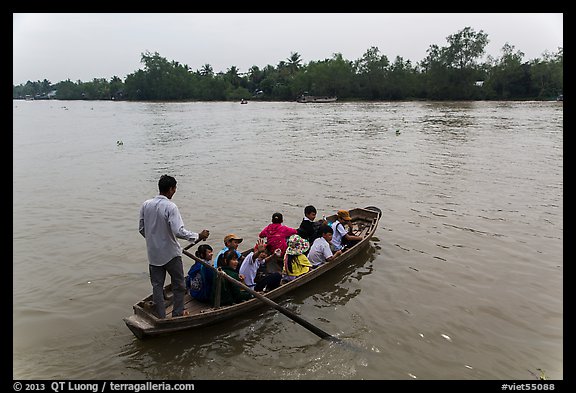 Schoolchildren crossing river on boat. Can Tho, Vietnam (color)