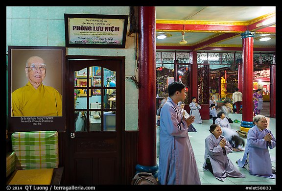 Women in prayer inside Quoc Tu pagoda. Ho Chi Minh City, Vietnam (color)