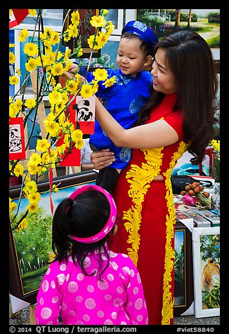 Woman and children in traditional dress for lunar new year. Ho Chi Minh City, Vietnam (color)