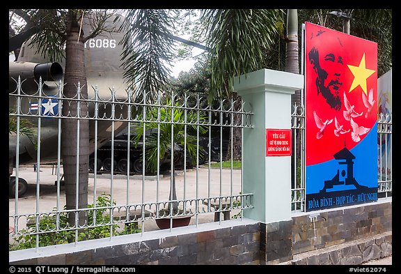 US Helicopter tail and fence with poster, War Remnants Museum, district 3. Ho Chi Minh City, Vietnam (color)