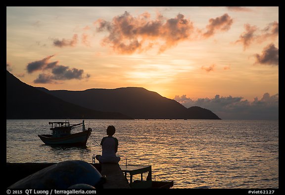 Silhouetted woman watching sunrise from Wharf 914, Con Son. Con Dao Islands, Vietnam (color)