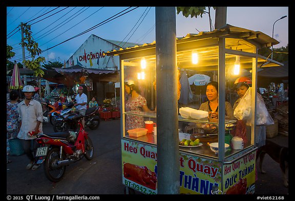 Food vendor at dusk, Con Dao Market, Con Son. Con Dao Islands, Vietnam (color)