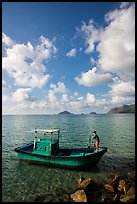 Fisherman lifting anchor from boat, Con Son. Con Dao Islands, Vietnam ( color)