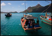 Sailor throws rope from boat, Ben Dam harbor. Con Dao Islands, Vietnam ( color)