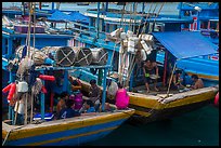 Sailors and families take lunch break at the back of boats, Ben Dam. Con Dao Islands, Vietnam ( color)