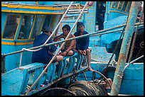 Fishermen relaxing on boats, Ben Dam. Con Dao Islands, Vietnam ( color)