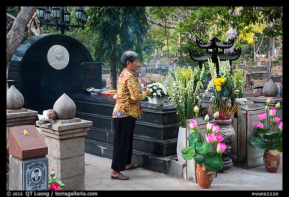 Woman offers incense at Vo Thi Sau grave. Con Dao Islands, Vietnam (color)