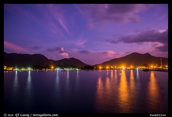 Lights of Con Son reflected in harbor at dawn. Con Dao Islands, Vietnam (color)