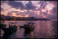 Men with light on fishing boat at dawn, Con Son harbor. Con Dao Islands, Vietnam ( color)