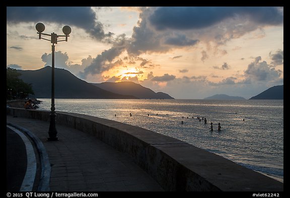 Seafront promenade and beachgoers at sunrise, Con Son. Con Dao Islands, Vietnam (color)