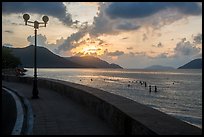 Seafront promenade and beachgoers at sunrise, Con Son. Con Dao Islands, Vietnam ( color)