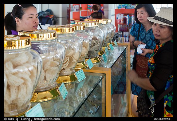 Women buying eddible birds nest. Con Dao Islands, Vietnam (color)