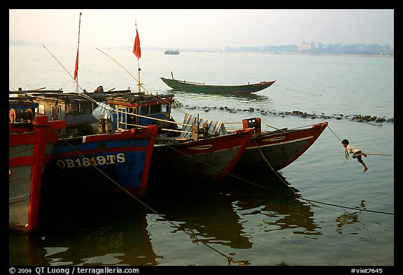 Children climbing aboard Fishing boat, Dong Hoi. Vietnam (color)