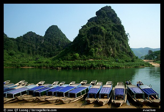 Tour boats and forest-covered limestone rocks, Son Trach. Vietnam (color)