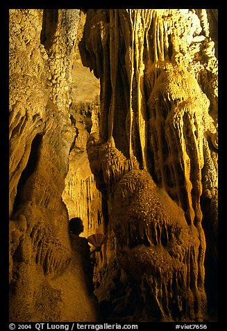 Tourist framed by cave formations, upper cave, Phong Nha Cave. Vietnam (color)