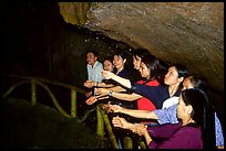 Women catch the water seeping from Tan Thanh Cave, said to have mirculous properties. Lang Son, Northest Vietnam ( color)