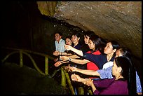 Women catch the water seeping from Tan Thanh Cave, said to have mirculous properties. Lang Son, Northest Vietnam (color)
