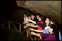 Women catch the water seeping from Tan Thanh Cave, said to have mirculous properties. Lang Son, Northest Vietnam