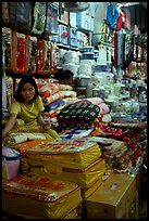 Vendor sitting amongst Abondance of cheap goods imported from nearby China at the Dong Kinh Market. Lang Son, Northest Vietnam