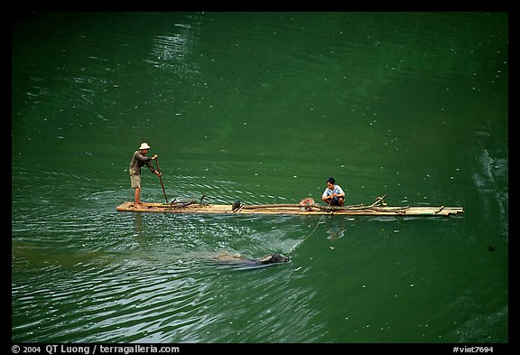 Crossing the Ky Cung  River on a narrow dugout boat. Northest Vietnam