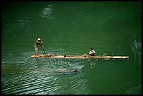 Crossing the Ky Cung  River on a narrow dugout boat. Northest Vietnam