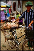 Man with a newly bought pig loaded on his bicycle, That Khe market. Northest Vietnam