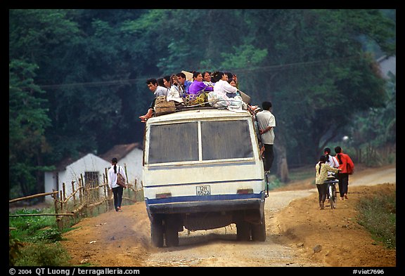 Passengers sitting on top of an overloaded bus. Northest Vietnam (color)