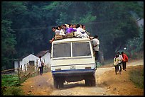 Passengers sitting on top of an overloaded bus. Northest Vietnam