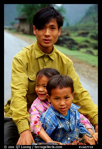 Young man carrying two kids on his bicycle. Northeast Vietnam