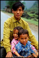 Young man carrying two kids on his bicycle. Northeast Vietnam (color)