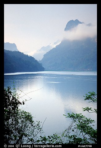 Morning mist on the tall cliffs surrounding Ba Be Lake. Northeast Vietnam