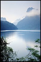 Morning mist on the tall cliffs surrounding Ba Be Lake. Northeast Vietnam (color)